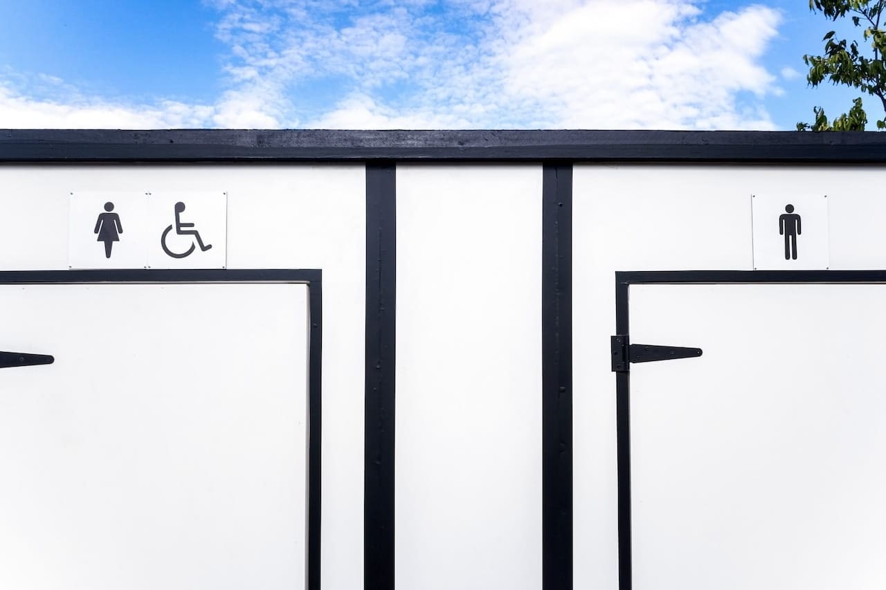 White portable toilets with space for women, men and disabled people.